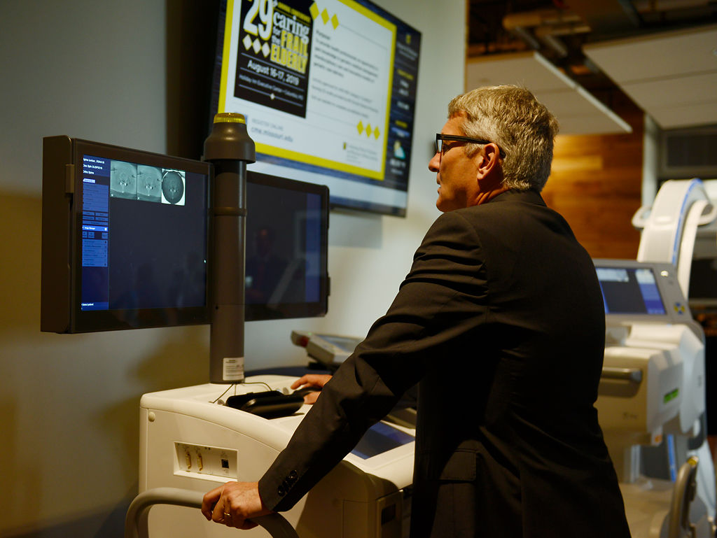 Herbert Westin, reads MRI results during a demonstration at the Alliance for Precision Health event